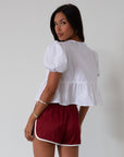 Satin shorts. Elastic waist. Side pockets. Unlined. cute track shorts. fashion track short. red shorts. red track shorts.