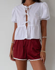Satin shorts. Elastic waist. Side pockets. Unlined. cute track shorts. fashion track short. red shorts. red track shorts.