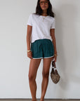 Satin shorts. Elastic waist. Side pockets. Unlined. cute track shorts. fashion track short. green shorts. green track shorts.
