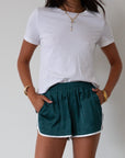 Satin shorts. Elastic waist. Side pockets. Unlined. cute track shorts. fashion track short. green shorts. green track shorts.
