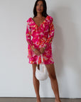 Printed chiffon dress. Long sleeves with tie closure. Front and back tie closures. Ruffle deep v-neckline. Side zipper closure. Fully lined. floral mini dress. pink floral mini dress