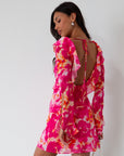 Printed chiffon dress. Long sleeves with tie closure. Front and back tie closures. Ruffle deep v-neckline. Side zipper closure. Fully lined. floral mini dress. pink floral mini dress