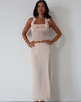 Chiffon crop top. Halter neckline with back button closures. Ruffle trimmed deep v-neckline. Side hook and eye and zipper closures. Partially lined. ruffle top. ruffle tank top. nude top. coquette top