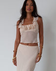 Chiffon crop top. Halter neckline with back button closures. Ruffle trimmed deep v-neckline. Side hook and eye and zipper closures. Partially lined. ruffle top. ruffle tank top. nude top. coquette top