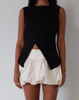 Woven skirt. Back hook and eye and zipper closures. Elastic bubble hem. Fully lined. cream bubble skirt. cream bubble mini skirt