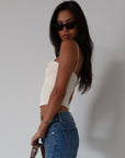 Woven crop top. Fixed straps. Back hook and eye and zipper closures. Fully lined. cream tank top. cream crop top tank. summer top. going out top