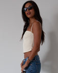 Woven crop top. Fixed straps. Back hook and eye and zipper closures. Fully lined. cream tank top. cream crop top tank. summer top. going out top