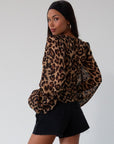 Animal printed chiffon top. Long sleeves with elastic openings. Underwire cups. Front lace up closures. Lace trim. Partially lined. leopard top. cheetah top. going out top. summer top