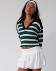 Striped ribbed knit crop top. Collar neckline. Long sleeves. Raw hem. Unlined. green and white stripe sweater long sleeve top