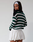 Striped ribbed knit crop top. Collar neckline. Long sleeves. Raw hem. Unlined. green and white stripe sweater long sleeve top