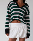 Striped ribbed knit crop top. Collar neckline. Long sleeves. Raw hem. Unlined. green and white stripe sweater long sleeve top