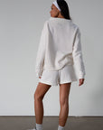 Knit shorts. Elastic waist and drawstring closure. Front pockets. Fleece lining. lounge shorts. sweat shorts. ivory sweat shorts. cream sweat shorts. loungewear