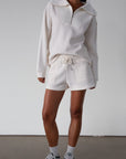 Knit shorts. Elastic waist and drawstring closure. Front pockets. Fleece lining. lounge shorts. sweat shorts. ivory sweat shorts. cream sweat shorts. loungewear