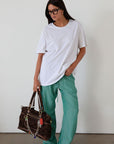 green Striped woven pants. Elastic waistband with drawstring closure. Side pockets. Unlined. fall transition outfit. lounge outfit. cute casual outfit