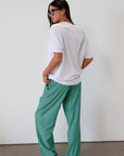 green Striped woven pants. Elastic waistband with drawstring closure. Side pockets. Unlined. fall transition outfit. lounge outfit. cute casual outfit