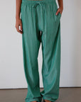 green Striped woven pants. Elastic waistband with drawstring closure. Side pockets. Unlined. fall transition outfit. lounge outfit. cute casual outfit