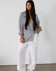 Striped woven shirt. Collar neckline. Long sleeves with button closure. Front button down closures. Front pocket. Unlined. 