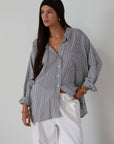 Striped woven shirt. Collar neckline. Long sleeves with button closure. Front button down closures. Front pocket. Unlined. 