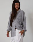 Striped woven shirt. Collar neckline. Long sleeves with button closure. Front button down closures. Front pocket. Unlined. 