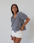white Knit ruffle eyelet mini shorts.