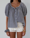 white Knit ruffle eyelet mini shorts.