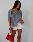 white Knit ruffle eyelet mini shorts.