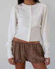 Knit cardigan. Long sleeves. Front button down closure. Banded hems. Unlined. white cardigan. fall transition outfit.