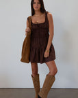 Smocked woven dress. Elastic straps. Front tie closure. Elastic waist. Side pockets. Fully lined. brown mini dress. fall transition dress