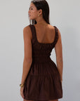 Smocked woven dress. Elastic straps. Front tie closure. Elastic waist. Side pockets. Fully lined. brown mini dress. fall transition dress