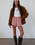 Checkered woven shorts. Elastic waist. Faux button fly. Ruffle trim hem. Unlined. red checkered shorts