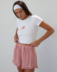 Checkered woven shorts. Elastic waist. Faux button fly. Ruffle trim hem. Unlined. red checkered shorts