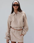 Denim skirt. Button and zipper fly. Four pocket construction. Unlined. tan denim skirt. fall outfit