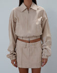 Denim skirt. Button and zipper fly. Four pocket construction. Unlined. tan denim skirt. fall outfit