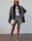 Plaid woven shorts. Elastic waistband. Faux button fly. Side pockets. Fully lined. plaid boxer shorts. black and white boxer shorts. fall outfit