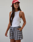 Plaid woven shorts. Elastic waistband. Faux button fly. Side pockets. Fully lined. plaid boxer shorts. black and white boxer shorts. fall outfit