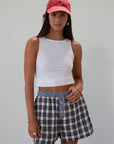 Plaid woven shorts. Elastic waistband. Faux button fly. Side pockets. Fully lined. plaid boxer shorts. black and white boxer shorts. fall outfit