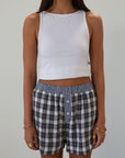Plaid woven shorts. Elastic waistband. Faux button fly. Side pockets. Fully lined. plaid boxer shorts. black and white boxer shorts. fall outfit
