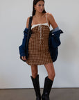 Polka dot printed satin dress. Adjustable straps. Front tie closure. Back hook and eye and zipper closures. Fully lined. brown mini dress. brown polka dot dress. fall outfit