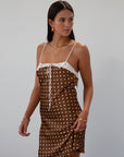 Polka dot printed satin dress. Adjustable straps. Front tie closure. Back hook and eye and zipper closures. Fully lined. brown mini dress. brown polka dot dress. fall outfit