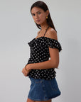 Polka dot printed chiffon crop top. Ruffle trim. Elastic off the shoulder short sleeves. Front tie closure. Boning in bodice. Back hook and eye and zipper closures. Fully lined. black polka dot top. going out top fall top. fall outfit.