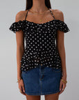 Polka dot printed chiffon crop top. Ruffle trim. Elastic off the shoulder short sleeves. Front tie closure. Boning in bodice. Back hook and eye and zipper closures. Fully lined. black polka dot top. going out top fall top. fall outfit.