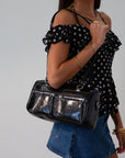 Vegan leather bag. Fixed top straps. Adjustable/detachable strap. Top zipper closure. Outer zipper pockets. Fully lined with inner zipper pocket.