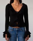 Crochet knit cropped sweater. Ruffle trim. Long sleeves. Front button down closures. Unlined. black sweater. black cardigan sweater. fall outfit