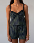green Checkered woven cropped tank. Lace trim. Adjustable straps. Front tie. Elastic back. Partially lined. fall outfit