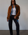 Mid rise bowed straight leg jeans. Button and zipper fly. Five pocket construction. Straight leg bows at the knees for an arched, barrel leg silhouette. Ankle length crop with a clean hem. No stretch. BLACK DENIM JEANS