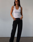 Mid rise bowed straight leg jeans. Button and zipper fly. Five pocket construction. Straight leg bows at the knees for an arched, barrel leg silhouette. Ankle length crop with a clean hem. No stretch. BLACK DENIM JEANS