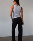 Mid rise bowed straight leg jeans. Button and zipper fly. Five pocket construction. Straight leg bows at the knees for an arched, barrel leg silhouette. Ankle length crop with a clean hem. No stretch. BLACK DENIM JEANS