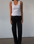 Mid rise bowed straight leg jeans. Button and zipper fly. Five pocket construction. Straight leg bows at the knees for an arched, barrel leg silhouette. Ankle length crop with a clean hem. No stretch. BLACK DENIM JEANS