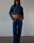 Cropped denim jacket. Collar neckline. Long sleeves with button closures. Front button closures. Unlined.