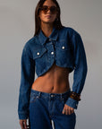 Cropped denim jacket. Collar neckline. Long sleeves with button closures. Front button closures. Unlined.